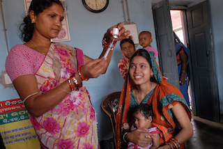 Community Health Worker Providing an Injection to a Local Woman