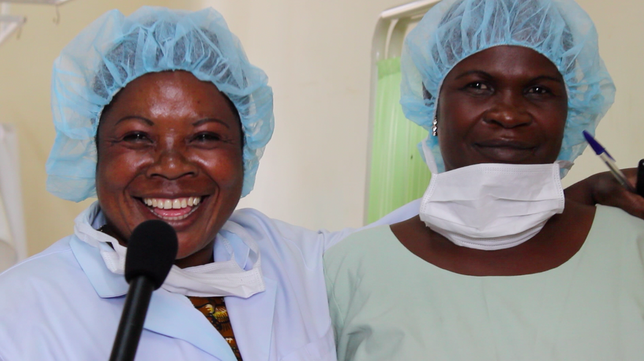 Image of two nurses smiling with their protective gear