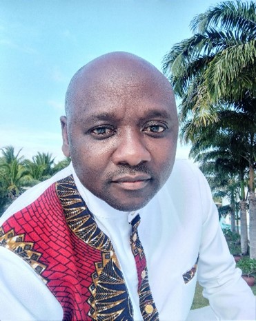 Picture of an African man in a white and red patterned shirt