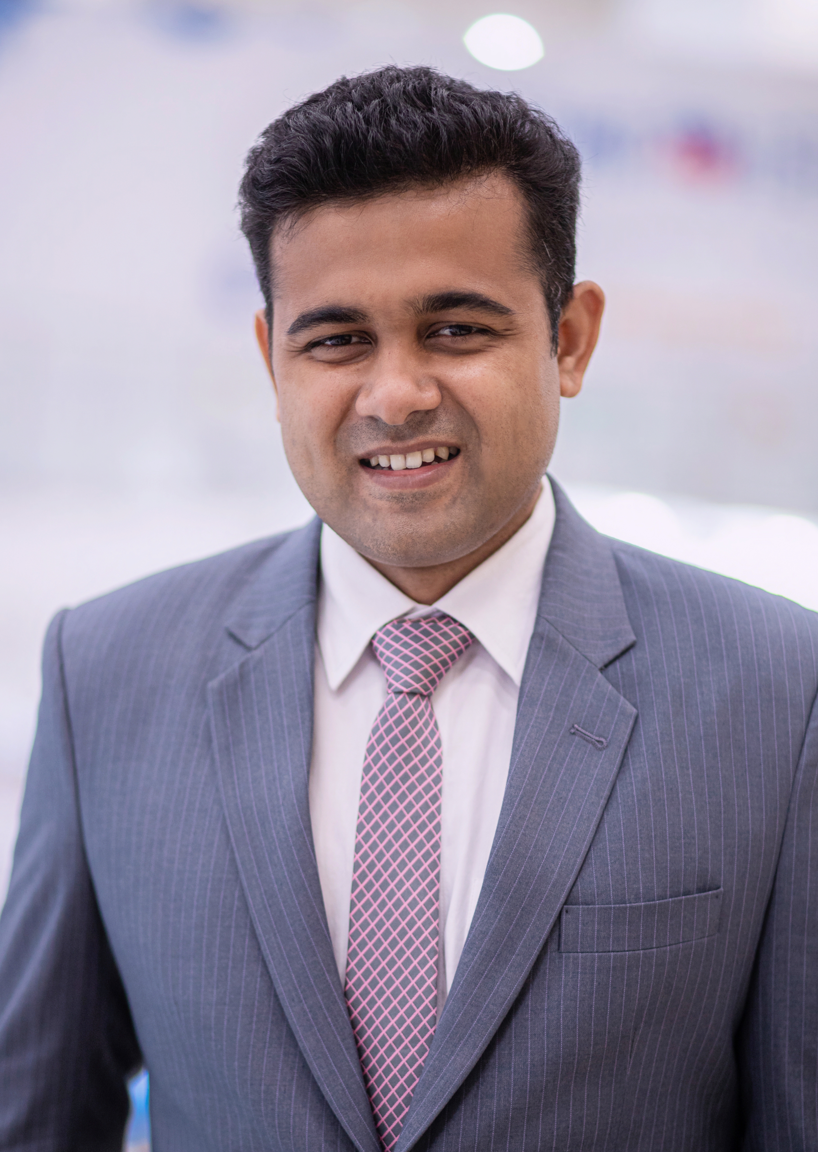 Photo of a young man in a grey suit