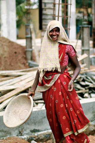 Young woman holding basket and smiling