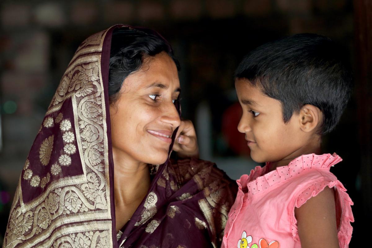 Woman holding her daughter